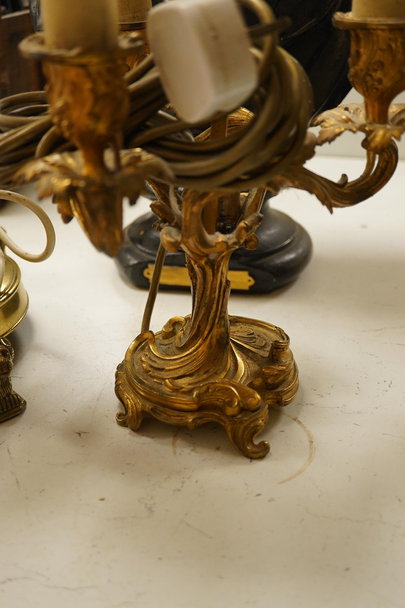 A plaster library bust possibly Keats?, an ormolu three light table lamp with red tole shade, 63cm high, and a large brass candlestick lamp on lion feet. Condition - fair to good